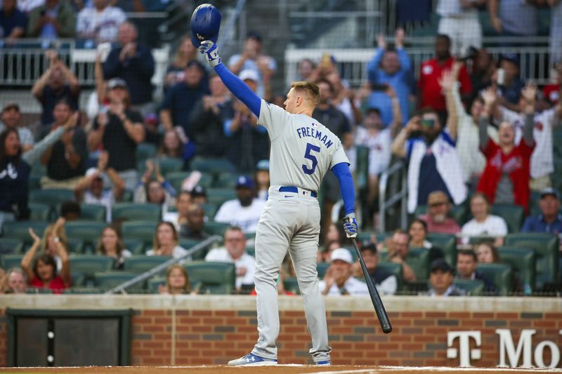 Sep 13, 2024; Atlanta, Georgia, USA; Los Angeles Dodgers first baseman Freddie Freeman (5) acknowledges the crowd before an at bat against the Atlanta Braves in the first inning at Truist Park. Mandatory Credit: Brett Davis-Imagn Images