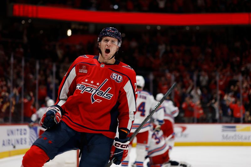 Jan 4, 2025; Washington, District of Columbia, USA; Washington Capitals center Aliaksei Protas (21) celebrates after scoring a goal against the New York Rangers in the third period at Capital One Arena. Mandatory Credit: Geoff Burke-Imagn Images