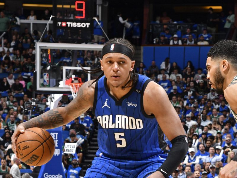 ORLANDO, FL - APRIL 25: Paolo Banchero #5 of the Orlando Magic handles the ball during the game against the Boston Celtics during Round 1 Game 3 of the 2025 NBA Playoffs on April 25, 2025 at Kia Center in Orlando, Florida. NOTE TO USER: User expressly acknowledges and agrees that, by downloading and or using this photograph, User is consenting to the terms and conditions of the Getty Images License Agreement. Mandatory Copyright Notice: Copyright 2025 NBAE(Photo by Gary Bassing/NBAE via Getty Images)