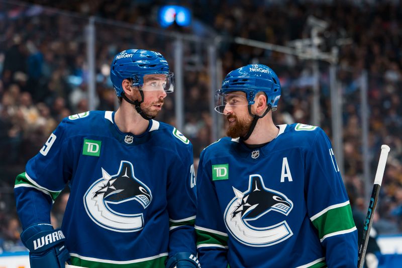 Jan 25, 2026; Vancouver, British Columbia, CAN; Vancouver Canucks defenseman Marcus Pettersson (29) talks with defenseman Filip Hronek (17) during a stop in play against the Pittsburgh Penguins in the first period at Rogers Arena. Mandatory Credit: Bob Frid-Imagn Images