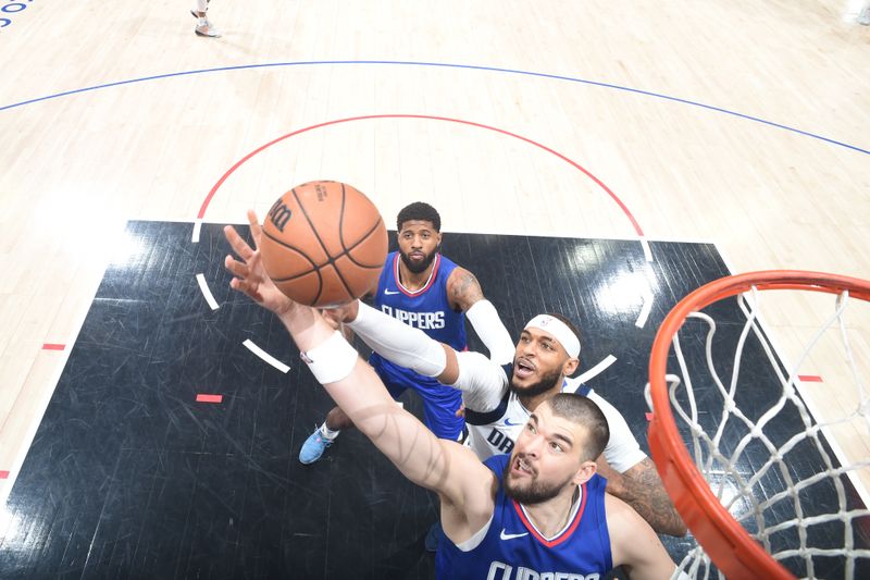 LOS ANGELES, CA - APRIL 21: Ivica Zubac #40 of the LA Clippers rebounds the ball during the game against the Dallas Mavericks during the 2024 NBA Playoffs on April 21, 2024 at Crypto.Com Arena in Los Angeles, California. NOTE TO USER: User expressly acknowledges and agrees that, by downloading and/or using this Photograph, user is consenting to the terms and conditions of the Getty Images License Agreement. Mandatory Copyright Notice: Copyright 2024 NBAE (Photo by Andrew D. Bernstein/NBAE via Getty Images)