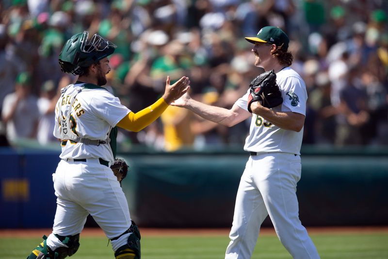 Jul 20, 2024; Oakland, California, USA; Oakland Athletics pitcher Tyler Ferguson (65) and Oakland Athletics catcher Shea Langeliers (23) celebrate their 8-2 victory over the Los Angeles Angels during the ninth inning at Oakland-Alameda County Coliseum. Mandatory Credit: D. Ross Cameron-USA TODAY Sports