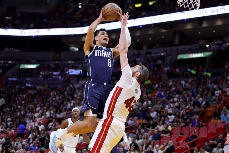 MIAMI, FLORIDA - APRIL 01: Josh Green #8 of the Dallas Mavericks shoots the ball against Kevin Love #42 of the Miami Heat during the first quarter at Miami-Dade Arena on April 01, 2023 in Miami, Florida. NOTE TO USER: User expressly acknowledges and agrees that, by downloading and or using this photograph, User is consenting to the terms and conditions of the Getty Images License Agreement. (Photo by Megan Briggs/Getty Images)