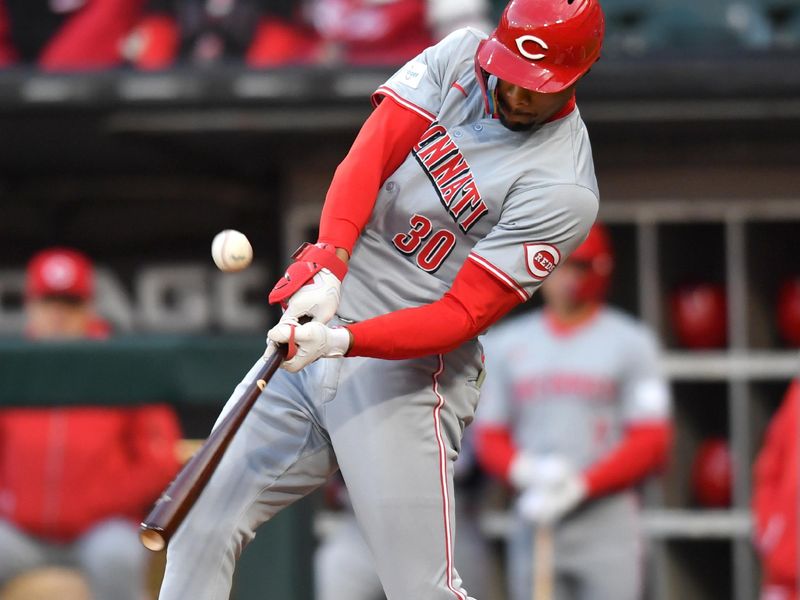 Apr 12, 2024; Chicago, Illinois, USA; Cincinnati Reds center fielder Will Benson (30) hits a double during the first inning against the Chicago White Sox at Guaranteed Rate Field. Mandatory Credit: Patrick Gorski-USA TODAY Sports