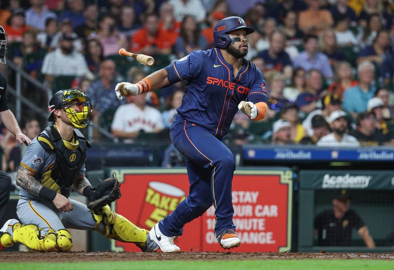 Jul 29, 2024; Houston, Texas, USA; Houston Astros first baseman Jon Singleton (28) hits a single during the fifth inning against the Pittsburgh Pirates at Minute Maid Park. Mandatory Credit: Troy Taormina-USA TODAY Sports