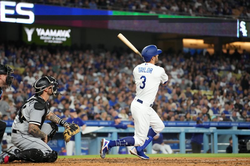 Jun 15, 2023; Los Angeles, California, USA; Los Angeles Dodgers third baseman Chris Taylor (3) follows through on a grand slam home run in the sixth inning as Chicago White Sox catcher Yasmani Grandal (24) watches at Dodger Stadium. Mandatory Credit: Kirby Lee-USA TODAY Sports