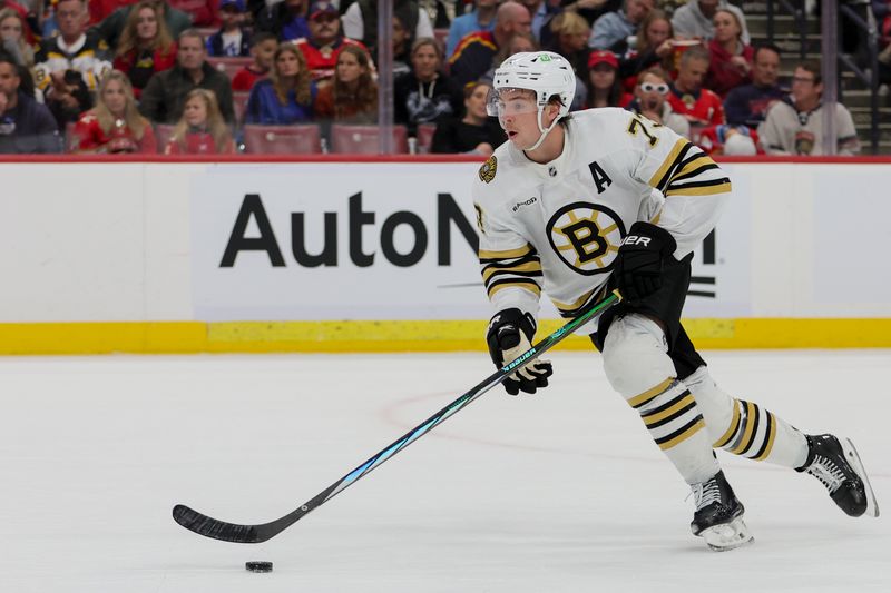 Nov 22, 2023; Sunrise, Florida, USA; Boston Bruins defenseman Charlie McAvoy (73) moves the puck against the Florida Panthers during the second period at Amerant Bank Arena. Mandatory Credit: Sam Navarro-USA TODAY Sports