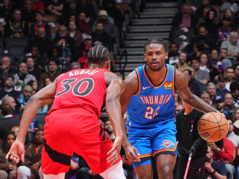 TORONTO, CANADA - DECEMBER 05:  Cason Wallace #22 of the Oklahoma City Thunder dribbles the ball during the game against the Toronto Raptors on December 05, 2024 at the Scotiabank Arena in Toronto, Ontario, Canada.  NOTE TO USER: User expressly acknowledges and agrees that, by downloading and or using this Photograph, user is consenting to the terms and conditions of the Getty Images License Agreement.  Mandatory Copyright Notice: Copyright 2024 NBAE (Photo by Mark Blinch/NBAE via Getty Images)