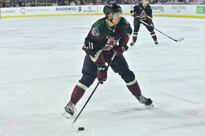 Feb 8, 2024; Tempe, Arizona, USA;  Arizona Coyotes right wing Dylan Guenther (11) looks to pass during the second period against the Vegas Golden Knights at Mullett Arena. Mandatory Credit: Matt Kartozian-USA TODAY Sports