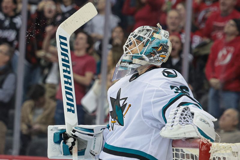 Dec 1, 2023; Newark, New Jersey, USA; San Jose Sharks goaltender Kaapo Kahkonen (36) looks up at the main scoreboard after allowing a goal during the first period against the New Jersey Devils at Prudential Center. Mandatory Credit: Vincent Carchietta-USA TODAY Sports