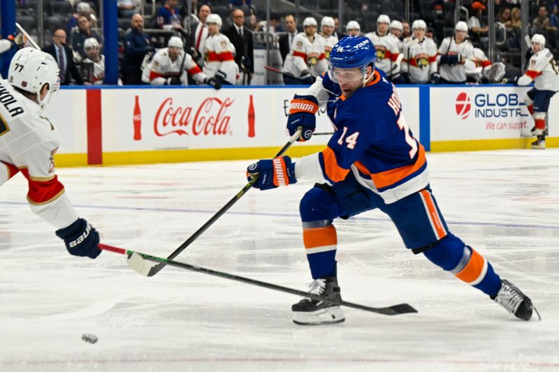 Mar 1, 2026; Elmont, New York, USA;  New York Islanders center Bo Horvat (14) attempts a shot against the Florida Panthers during the first period at UBS Arena. Mandatory Credit: Dennis Schneidler-Imagn Images
