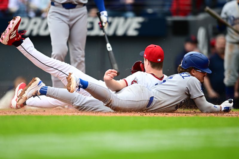 May 28, 2025; Cleveland, Ohio, USA; Los Angeles Dodgers first baseman Kike Hernandez (8) scores on a wild pitch as Cleveland Guardians relief pitcher Tim Herrin (29) defends the plate during the seventh inning at Progressive Field. Mandatory Credit: Ken Blaze-Imagn Images