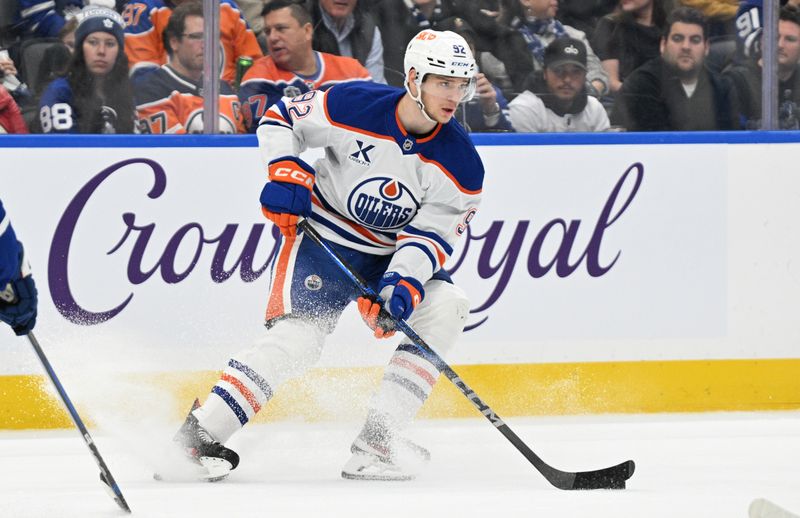 Nov 16, 2024; Toronto, Ontario, CAN;  Edmonton Oilers forward Vasily Podkolzin (92) skates with the puck against the Toronto Maple Leafs in the first period at Scotiabank Arena. Mandatory Credit: Dan Hamilton-Imagn Images