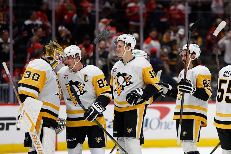 Nov 8, 2024; Washington, District of Columbia, USA; Pittsburgh Penguins goaltender Joel Blomqvist (30) celebrates with Penguins center Sidney Crosby (87) after their game against the Washington Capitals at Capital One Arena. Mandatory Credit: Geoff Burke-Imagn Images