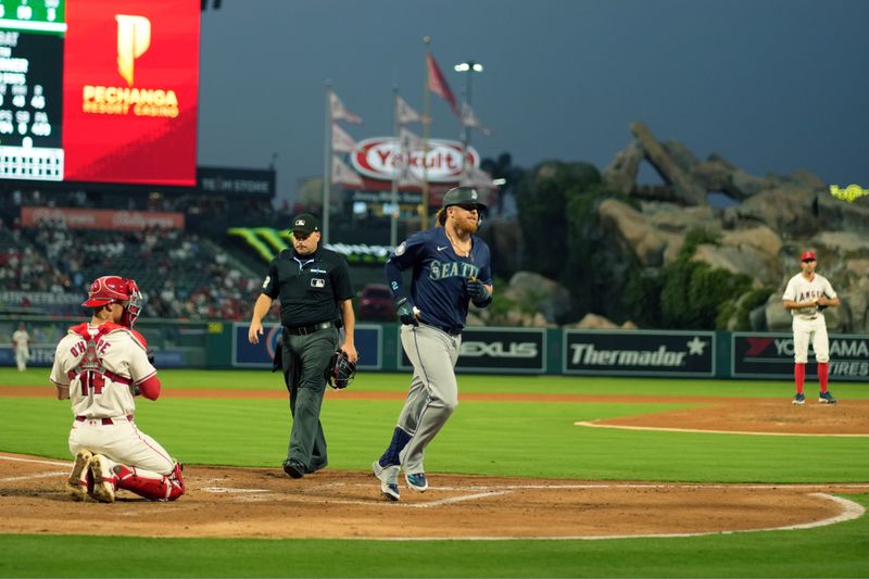 Aug 31, 2024; Anaheim, California, USA; Seattle Mariners first baseman Justin Turner (2) crosses home plate after hitting a home run in the third inning as Los Angeles Angels catcher Logan O'Hoppe (14) and starting pitcher Tyler Anderson (31)] watch at Angel Stadium. Mandatory Credit: Kirby Lee-USA TODAY Sports