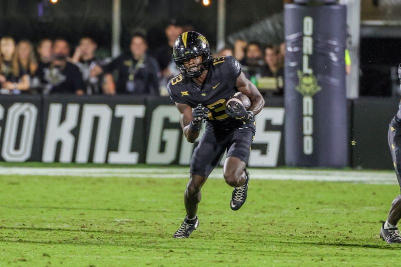 Oct 4, 2025; Orlando, Florida, USA; UCF Knights wide receiver Chris Domercant (13) carries the ball during the second half against the Kansas Jayhawks at FBC Mortgage Stadium. Mandatory Credit: Mike Watters-Imagn Images