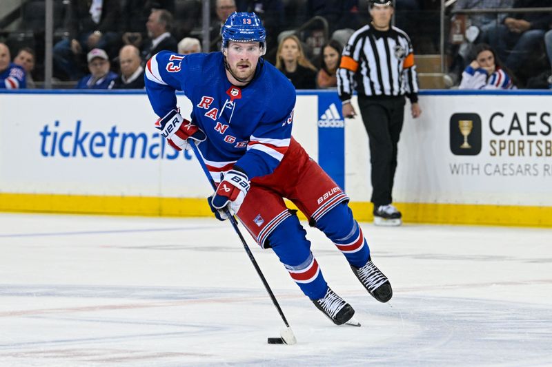 Apr 23, 2024; New York, New York, USA;  New York Rangers left wing Alexis Lafrenière (13) skates with the puck against the Washington Capitals during the third period in game two of the first round of the 2024 Stanley Cup Playoffs at Madison Square Garden. Mandatory Credit: Dennis Schneidler-USA TODAY Sports