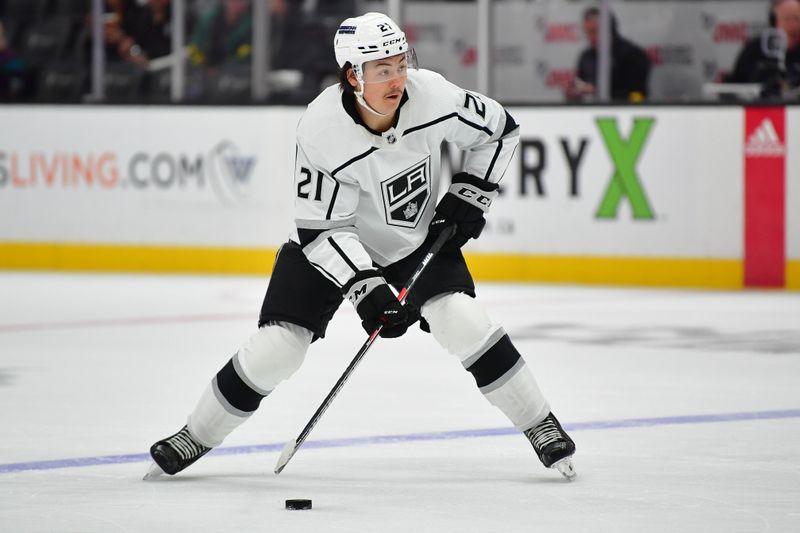 Nov 24, 2023; Anaheim, California, USA; Los Angeles Kings center Trevor Moore (12) controls the puck against the Anaheim Ducks during the first period at Honda Center. Mandatory Credit: Gary A. Vasquez-USA TODAY Sports