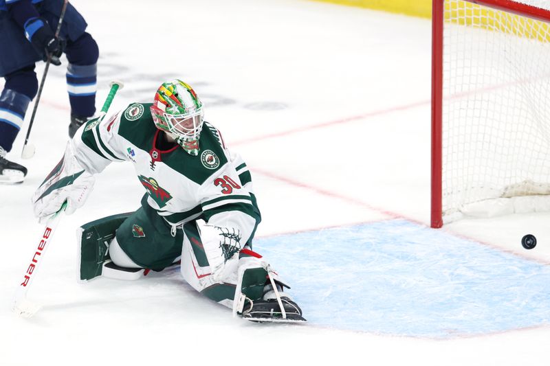 Dec 27, 2025; Winnipeg, Manitoba, CAN; Winnipeg Jets center Mark Scheifele (55) (not shown) scores on Minnesota Wild goaltender Jesper Wallstedt (30) in the second period at Canada Life Centre. Mandatory Credit: James Carey Lauder-Imagn Images
