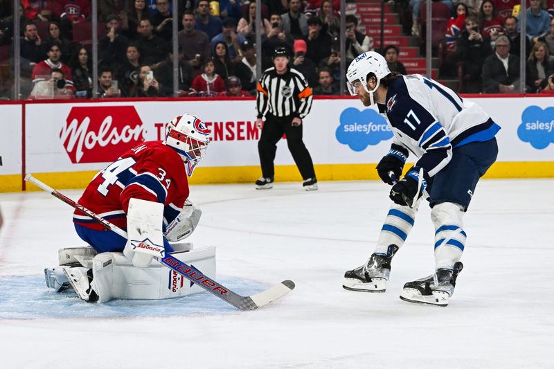 Oct 28, 2023; Montreal, Quebec, CAN; Winnipeg Jets center Adam Lowry (17) scores on a penalty shot against Montreal Canadiens goalie Jake Allen (34) during the first period at Bell Centre. Mandatory Credit: David Kirouac-USA TODAY Sports