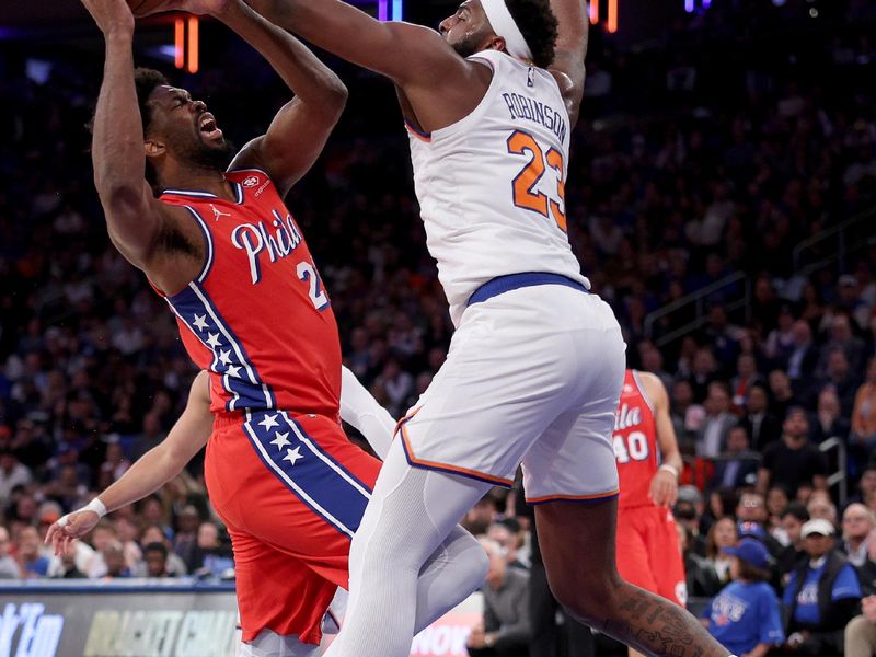 NEW YORK, NEW YORK - APRIL 20: Joel Embiid #21 of the Philadelphia 76ers heads for the net as Mitchell Robinson #23 of the New York Knicks defends during the first half in game one of the Eastern Conference First Round Playoffs at Madison Square Garden on April 20, 2024 in New York City. NOTE TO USER: User expressly acknowledges and agrees that, by downloading and or using this photograph, User is consenting to the terms and conditions of the Getty Images License Agreement. (Photo by Elsa/Getty Images)
