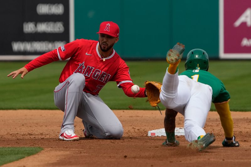 Mar 23, 2024; Mesa, Arizona, USA; Los Angeles Angels second baseman Livan Soto (73) tags out Oakland Athletics center fielder Esteury Ruiz (1) trying to steal in the second inning at Hohokam Stadium. Mandatory Credit: Rick Scuteri-USA TODAY Sports