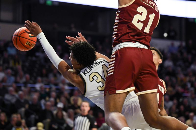 Feb 28, 2023; Winston-Salem, North Carolina, USA; Wake Forest Demon Deacons forward Bobi Klintman (34) is fouled driving to the basket during the first half at Lawrence Joel Veterans Memorial Coliseum. Mandatory Credit: William Howard-USA TODAY Sports