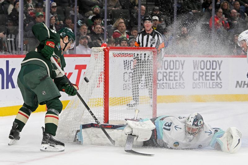 Mar 19, 2025; Saint Paul, Minnesota, USA;  Seattle Kraken goalie Philipp Grubauer (31) makes a save on Minnesota Wild forward Liam Ohgren (28) during the second period at Xcel Energy Center. Mandatory Credit: Nick Wosika-Imagn Images