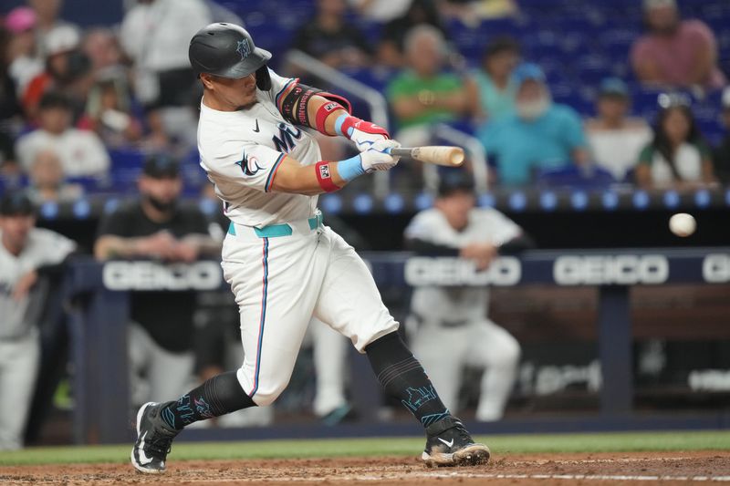 Aug 20, 2025; Miami, Florida, USA;  Miami Marlins designated hitter Heriberto Hernandez (64) hits a single and drives in two runs in the third inning against the St. Louis Cardinals at loanDepot Park. Mandatory Credit: Jim Rassol-Imagn Images