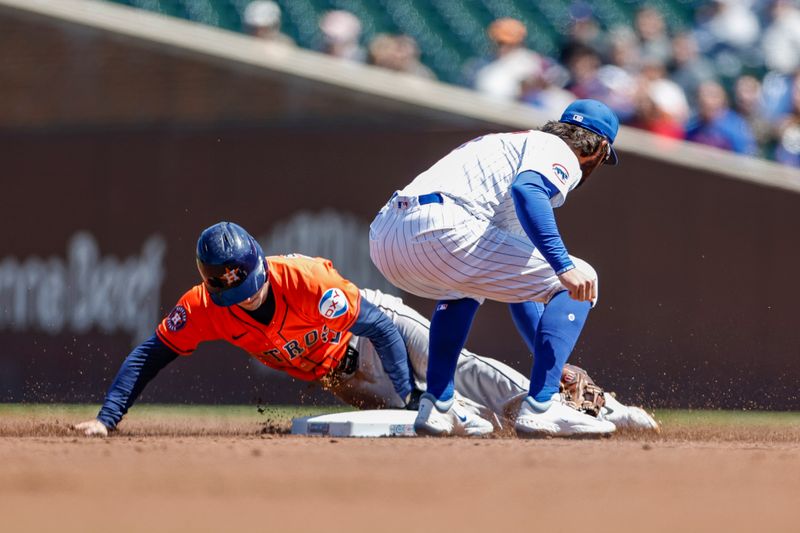 Apr 25, 2024; Chicago, Illinois, USA; Houston Astros third baseman Alex Bregman (2) steals second base against Chicago Cubs shortstop Dansby Swanson (7) during the first inning at Wrigley Field. Mandatory Credit: Kamil Krzaczynski-USA TODAY Sports