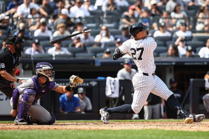 Aug 25, 2024; Bronx, New York, USA;  New York Yankees designated hitter Giancarlo Stanton (27) breaks hits bat while hitting a single in the fifth inning against the Colorado Rockies at Yankee Stadium. Mandatory Credit: Wendell Cruz-USA TODAY Sports