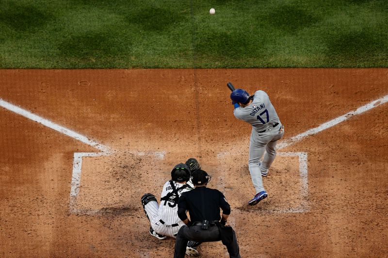 Jun 18, 2024; Denver, Colorado, USA; Los Angeles Dodgers designated hitter Shohei Ohtani (17) hits a solo home run in the sixth inning against the Colorado Rockies at Coors Field. Mandatory Credit: Isaiah J. Downing-USA TODAY Sports