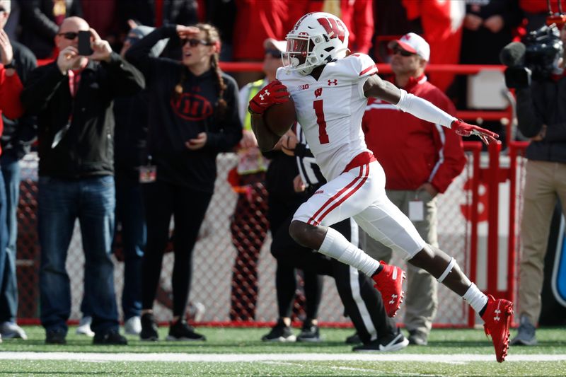 Nov 16, 2019; Lincoln, NE, USA; Wisconsin Badgers wide receiver Aron Cruickshank (1) scores a touchdown on a 99-yard kickoff return against Nebraska Cornhuskers in the first half at Memorial Stadium. Mandatory Credit: Bruce Thorson-USA TODAY Sports