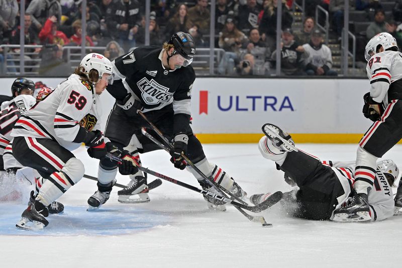 Dec 4, 2025; Los Angeles, California, USA;  Los Angeles Kings left wing Warren Foegele (37) and Chicago Blackhawks left wing Tyler Bertuzzi (59) battle for control of the puck in front of the net during the second period at Crypto.com Arena. Mandatory Credit: Jayne Kamin-Oncea-Imagn Images