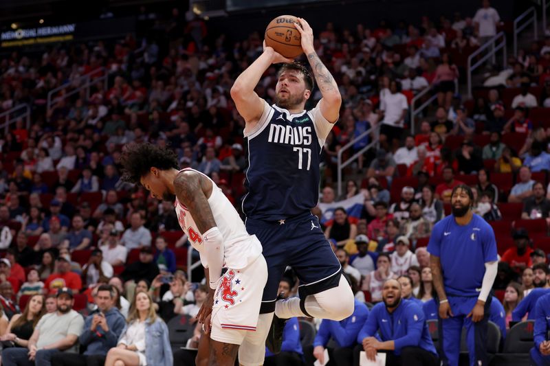 HOUSTON, TEXAS - MARCH 31: Luka Doncic #77 of the Dallas Mavericks shoots the ball while defended by Jalen Green #4 of the Houston Rockets in the first half at Toyota Center on March 31, 2024 in Houston, Texas.  NOTE TO USER: User expressly acknowledges and agrees that, by downloading and or using this photograph, User is consenting to the terms and conditions of the Getty Images License Agreement. (Photo by Tim Warner/Getty Images)