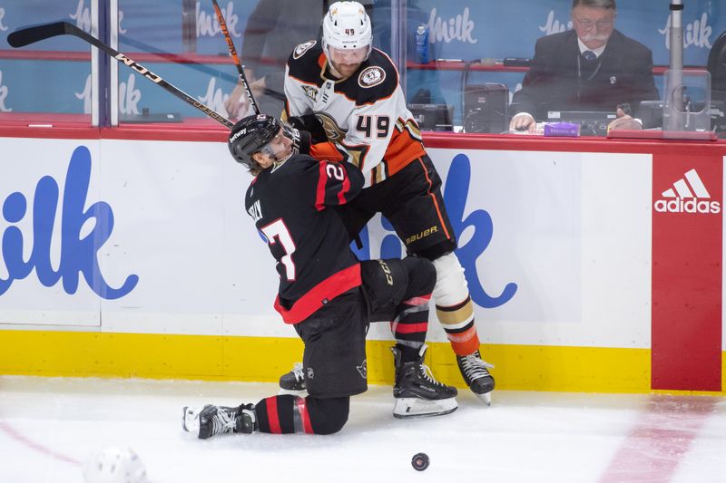 Feb 15, 2024; Ottawa, Ontario, CAN; Ottawa Senators left wing Parker Kelly (27) battles with Anaheim Ducks left wing Max Jones (49) in the third period at the Canadian Tire Centre. Mandatory Credit: Marc DesRosiers-USA TODAY Sports