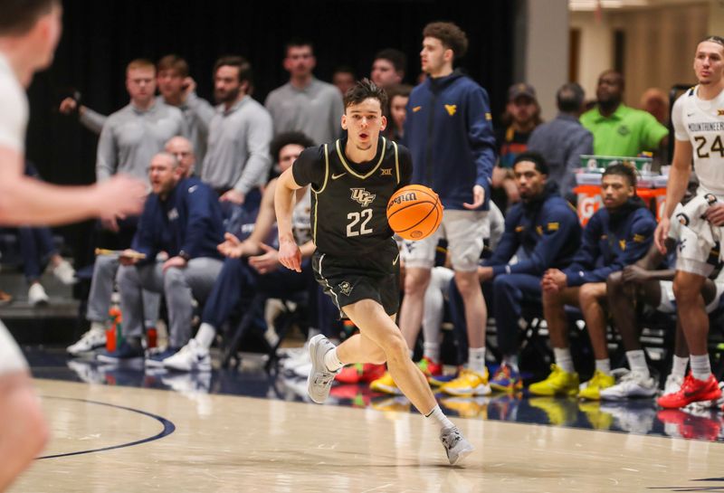 Feb 20, 2024; Morgantown, West Virginia, USA; UCF Knights guard Nils Machowski (22) dribbles the ball up the floor during the second half against the West Virginia Mountaineers at WVU Coliseum. Mandatory Credit: Ben Queen-USA TODAY Sports