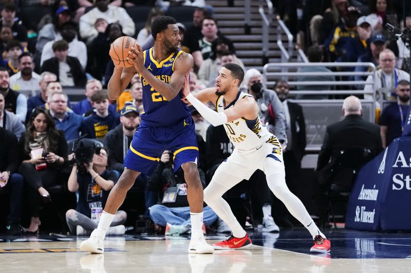 INDIANAPOLIS, INDIANA - FEBRUARY 08: Andrew Wiggins #22 of the Golden State Warriors handles the ball while being guarded by Tyrese Haliburton #0 of the Indiana Pacers in the second quarter at Gainbridge Fieldhouse on February 08, 2024 in Indianapolis, Indiana. NOTE TO USER: User expressly acknowledges and agrees that, by downloading and or using this photograph, User is consenting to the terms and conditions of the Getty Images License Agreement. (Photo by Dylan Buell/Getty Images)