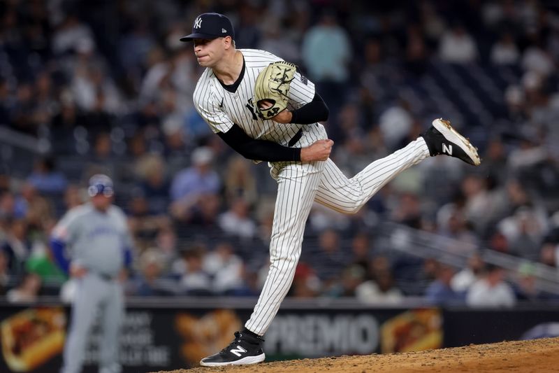 Sep 9, 2024; Bronx, New York, USA; New York Yankees relief pitcher Jake Cousins (61) follows through on a pitch against the Kansas City Royals during the seventh inning at Yankee Stadium. Mandatory Credit: Brad Penner-Imagn Images