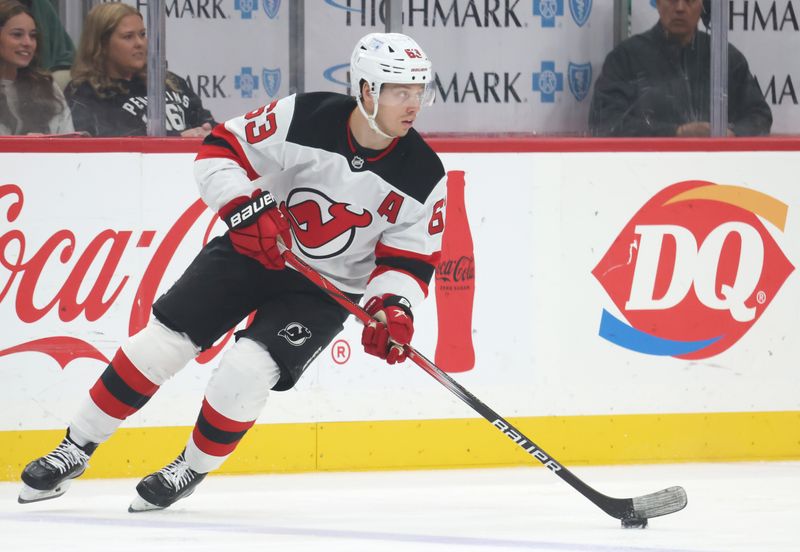 Mar 15, 2025; Pittsburgh, Pennsylvania, USA;  New Jersey Devils left wing Jesper Bratt (63) skates with the puck against the Pittsburgh Penguins during the third period at PPG Paints Arena. Mandatory Credit: Charles LeClaire-Imagn Images