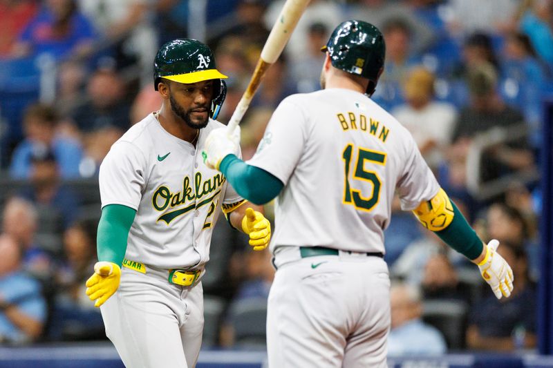 May 28, 2024; St. Petersburg, Florida, USA;  Oakland Athletics outfielder Miguel Andujar (22) celebrates with outfielder Seth Brown (15) after hitting a three-run home run against the Tampa Bay Rays in the sixth inning  at Tropicana Field. Mandatory Credit: Nathan Ray Seebeck-USA TODAY Sports