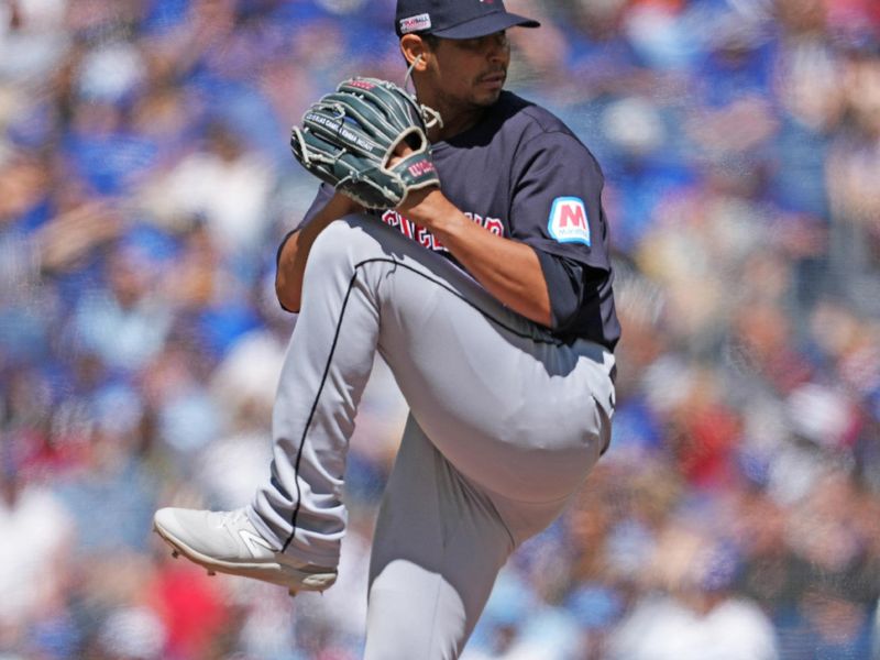 Jun 15, 2024; Toronto, Ontario, CAN; Cleveland Guardians starting pitcher Carlos Carrasco (59) throws a pitch against the Toronto Blue Jays during the first inning at Rogers Centre. Mandatory Credit: Nick Turchiaro-USA TODAY Sports