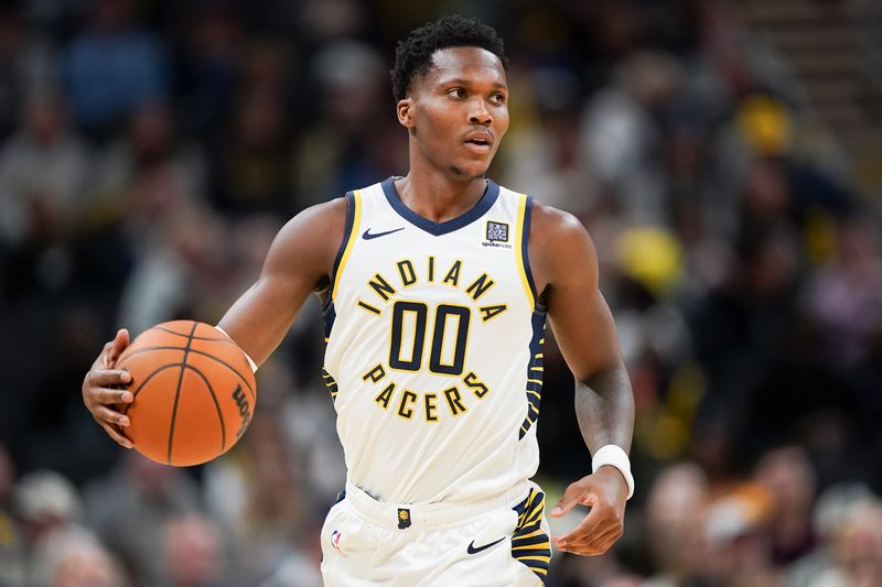 INDIANAPOLIS, INDIANA - OCTOBER 14: Bennedict Mathurin #00 of the Indiana Pacers dribbles the ball in the first quarter against the Memphis Grizzlies during a preseason game at Gainbridge Fieldhouse on October 14, 2024 in Indianapolis, Indiana. NOTE TO USER: User expressly acknowledges and agrees that, by downloading and or using this photograph, User is consenting to the terms and conditions of the Getty Images License Agreement. (Photo by Dylan Buell/Getty Images)
