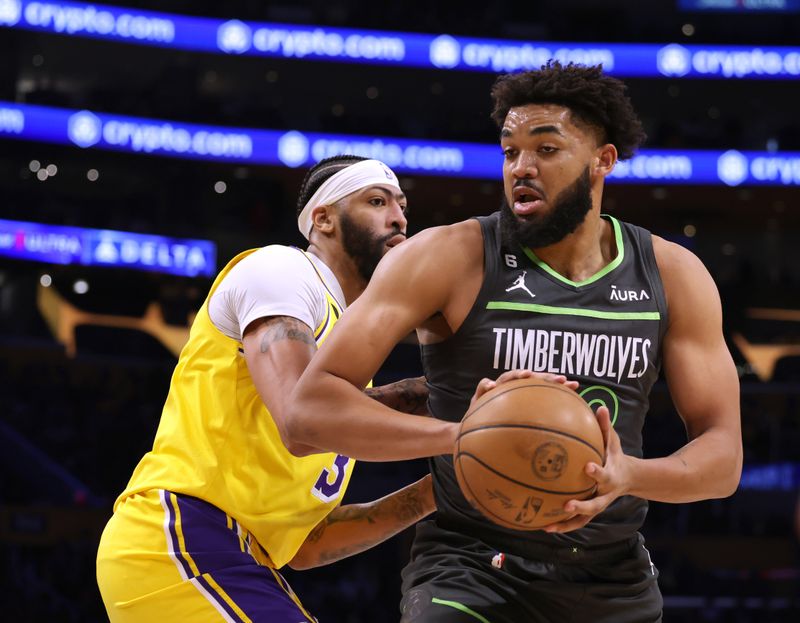 LOS ANGELES, CALIFORNIA - APRIL 11: Karl-Anthony Towns #32 of the Minnesota Timberwolves spins from Anthony Davis #3 of the Los Angeles Lakers during the first half in a play-in tournament game at Crypto.com Arena on April 11, 2023 in Los Angeles, California. NOTE TO USER: User expressly acknowledges and agrees that, by downloading and or using this photograph, User is consenting to the terms and conditions of the Getty Images License Agreement. (Photo by Harry How/Getty Images)