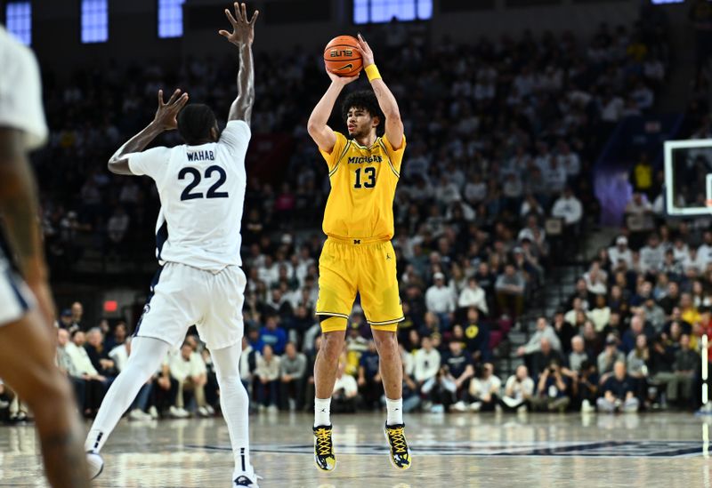 Jan 7, 2024; Philadelphia, Pennsylvania, USA; Michigan Wolverines forward Olivier Nkamhoua (13) shoots against Penn State Nittany Lions forward Qudus Wahab (22) in the second half at The Palestra. Mandatory Credit: Kyle Ross-USA TODAY Sports