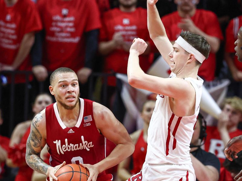 Feb 14, 2023; Piscataway, New Jersey, USA; Nebraska Cornhuskers guard C.J. Wilcher (0) looks to pass as Rutgers Scarlet Knights guard Paul Mulcahy (4) defends during the second half at Jersey Mike's Arena. Mandatory Credit: Vincent Carchietta-USA TODAY Sports