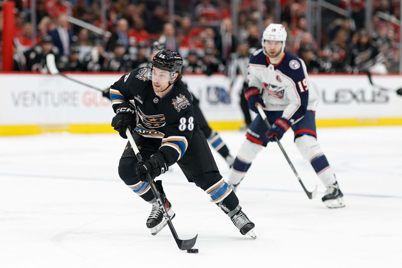 Apr 13, 2025; Washington, District of Columbia, USA; Washington Capitals left wing Andrew Mangiapane (88) skates with the puck as Columbus Blue Jackets center Adam Fantilli (19) chases in the third period at Capital One Arena. Mandatory Credit: Geoff Burke-Imagn Images