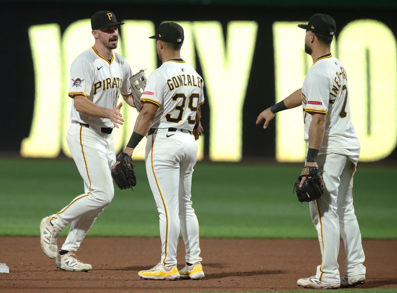 Jun 30, 2025; Pittsburgh, Pennsylvania, USA;  Pittsburgh Pirates right fielder Bryan Reynolds (10) and second baseman Nick Gonzales (39) and shortstop Isiah Kiner-Falefa (7) celebrate after defeating the St. Louis Cardinals  at PNC Park. Mandatory Credit: Charles LeClaire-Imagn Images