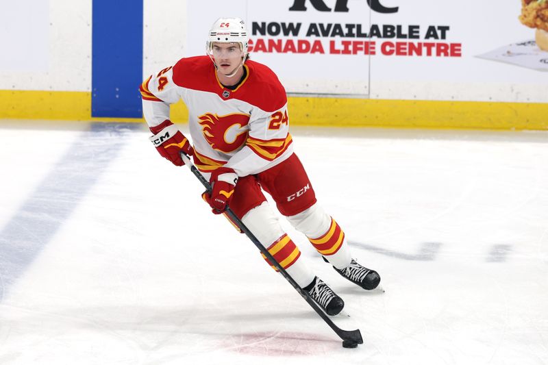 Jan 18, 2025; Winnipeg, Manitoba, CAN; Calgary Flames defenseman Jake Bean (24) warms up before a game against the Winnipeg Jets at Canada Life Centre. Mandatory Credit: James Carey Lauder-Imagn Images