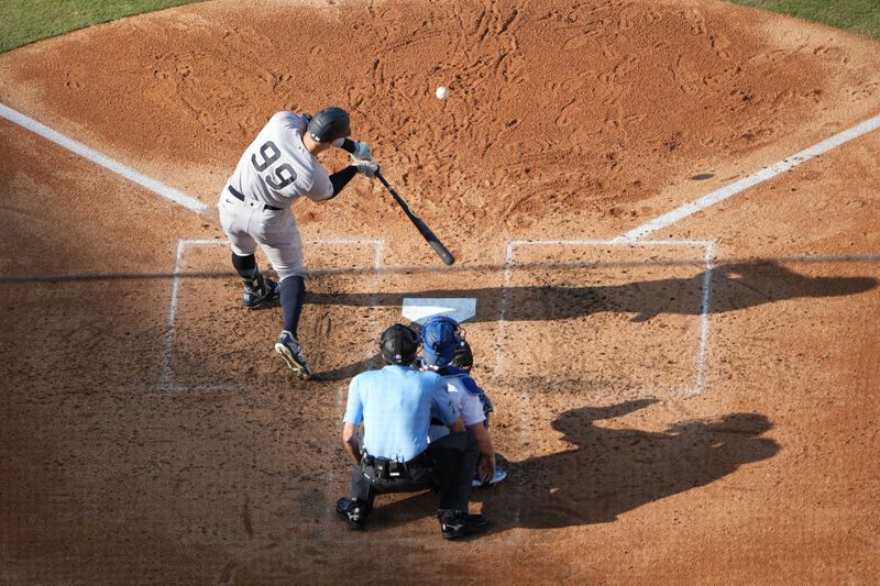 Jun 3, 2023; Los Angeles, California, USA; New York Yankees right fielder Aaron Judge (99) follows through on a home run in the sixth inning as Los Angeles Dodgers catcher Will Smith (16) and home plate umpire John Tumpane (74) watch at Dodger Stadium. Mandatory Credit: Kirby Lee-USA TODAY Sports